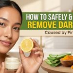 A woman applying a small amount of face cream to her cheek, surrounded by natural ingredients like turmeric root, tea tree leaves, and a cut lemon.