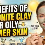 A person applying a gray Bentonite clay face mask to their T-zone to control excess oil and acne.