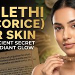 A wooden bowl filled with Mulethi powder and dried licorice roots sitting next to a bottle of rose water.