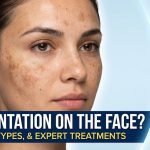 A woman applying a brightening Vitamin C serum to her cheek to treat hyperpigmentation and dark spots.