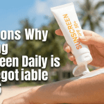 A person applying sunscreen to their face while looking in a mirror.